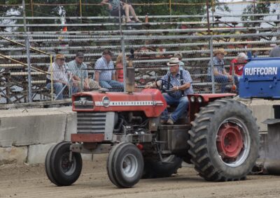 A man sitting on the back of a tractor.